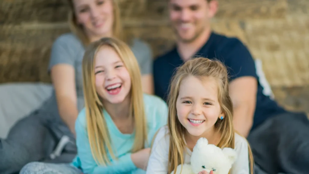 Girls laughing as dad shares the sunday Jokes to make their day amazing