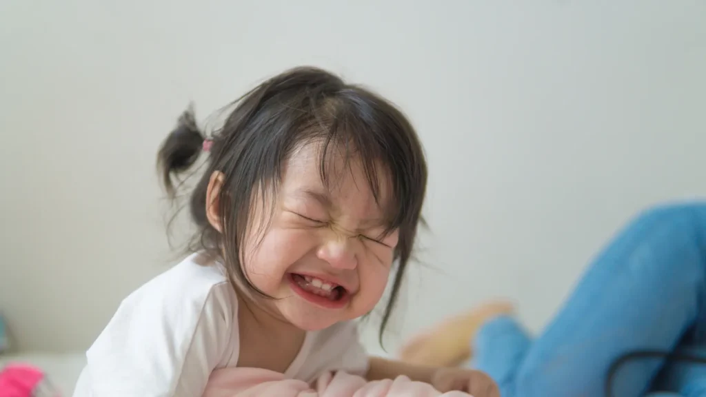 Little Girl laughing as dad shares Tuesday jokes to make her day