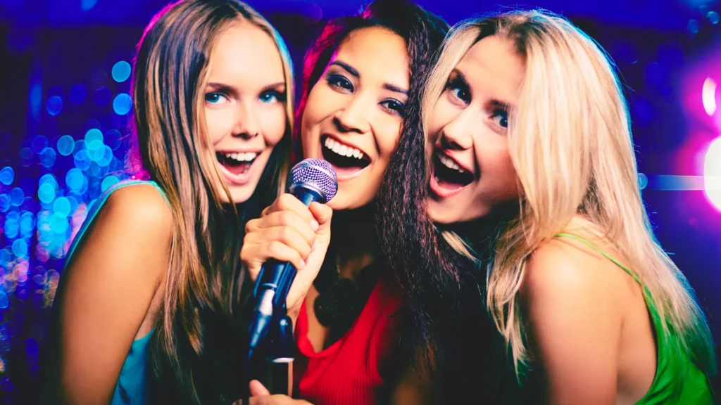 Three Girls at Karaoke Night Trying to Sing Songs