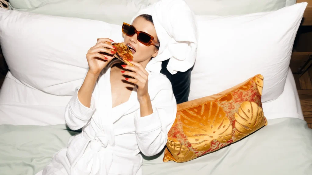 Woman making Mayonnaise jokes by wearing white clothes and a Colored pillow on bed